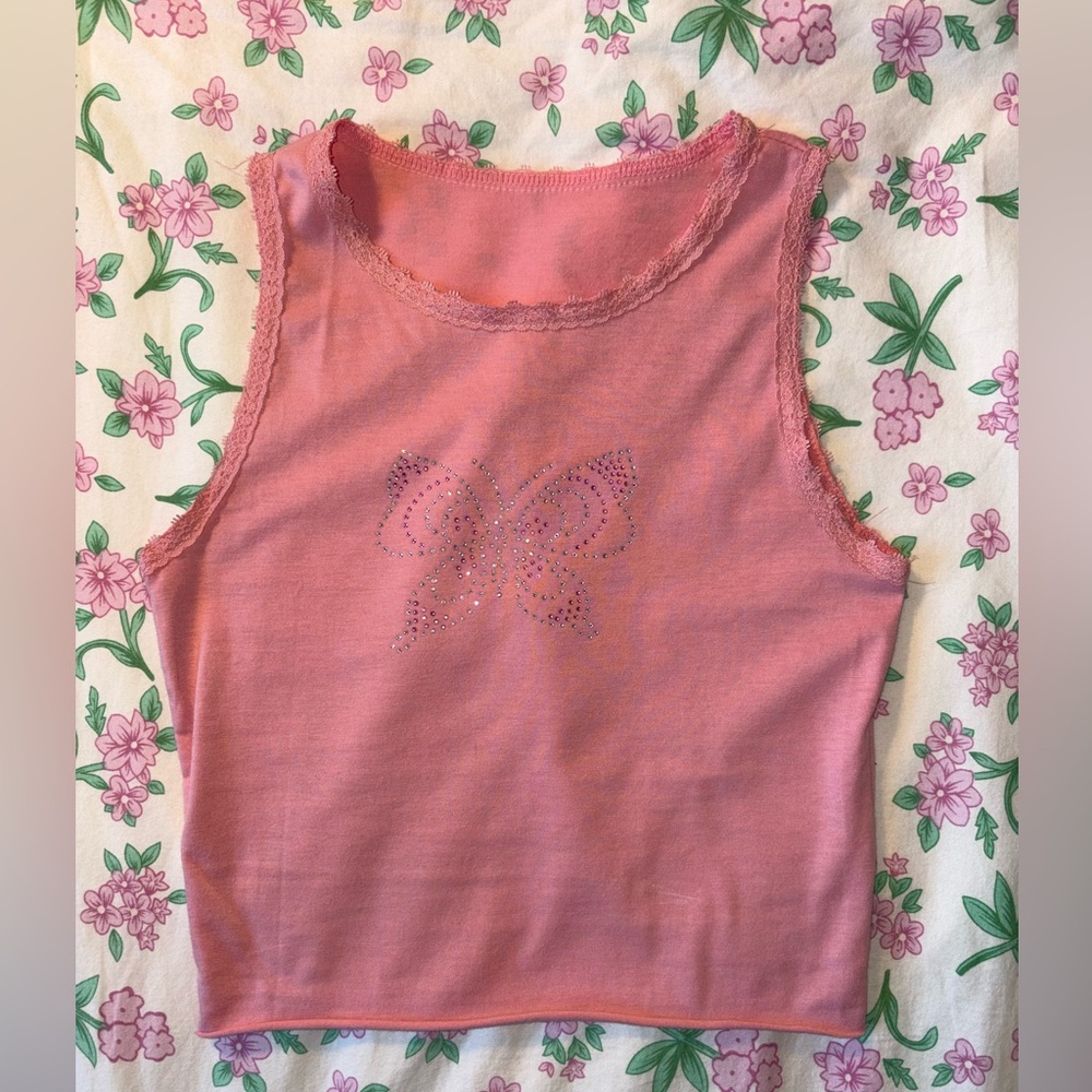 peachy pink cropped tank top with lace trim and rhinestone butterfly graphic